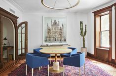 a dining room table with blue chairs around it