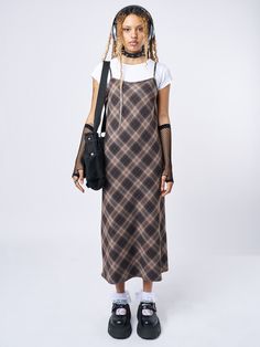 Shop our edit of trending y2k, dark academia, and grunge-inspired fashion staples like our Delia Brown Plaid Maxi Dress in brown with a check plaid pattern. Perfect for layering and ethically made to last. International shipping available.