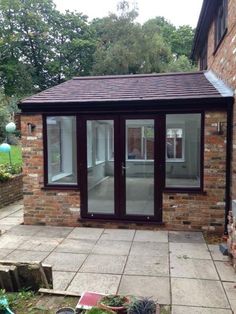 a small brick building with sliding glass doors