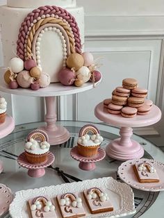 a table topped with lots of cakes and cupcakes