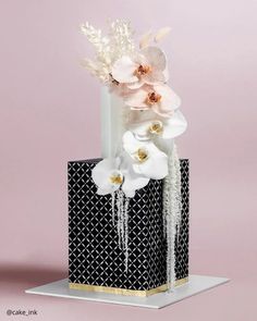 a black and white vase with flowers in it