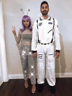 a man and woman dressed up in space suits