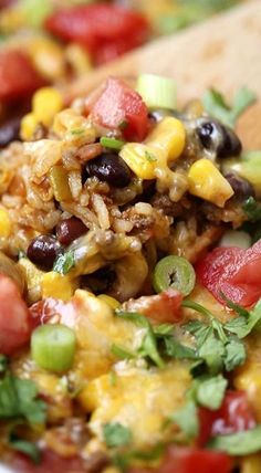 mexican rice salad with black beans, corn and cilantro on a wooden spoon