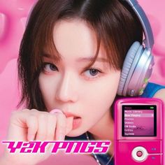 the girl is listening to music on her pink mp3 player