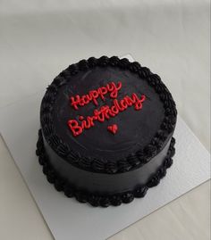 a birthday cake with the words happy birthday written in red frosting on top of it