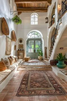 a living room filled with lots of furniture and rugs on top of tiled flooring