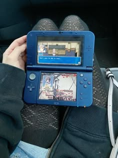 a person holding up a game system in their lap