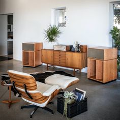 a living room filled with furniture and plants