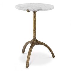 a white marble top table with an iron base and wooden legs, on a white background