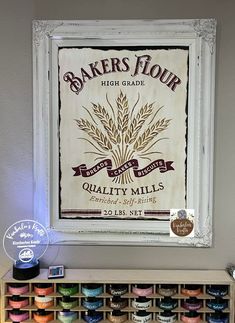 the bakers flour sign hangs on the wall next to an assortment of cakes and cupcakes