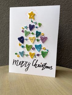 a christmas tree made out of buttons on a card