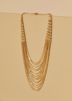 Chains on chains on chains!!! Shine bright all night into the morning wearing our gold-tone multichained necklace. Gold-tone Party Necklace, Multi-strand Delicate Chain Necklace For Party, Delicate Multi-strand Chain Necklace For Party, Gold Double Chain Necklace For Party, Gold Layered Snake Chain Necklace, Multi-strand Chunky Chain Jewelry For Parties, Party Double Chain Gold-tone Necklaces, Party Double Chain Multi-strand Necklace, Gold-tone Double Chain Necklace For Party