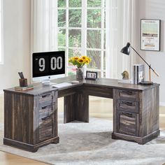 an l - shaped desk with drawers and a clock on it