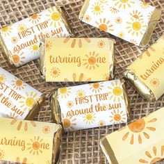 gold foil wrapped candy wrappers that say, first trip around the sun