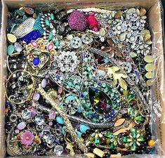 a box filled with lots of different colored beads