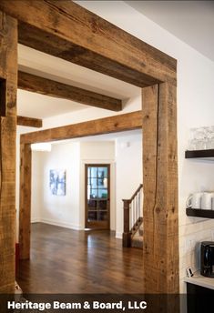 the inside of a house with wood floors and beams