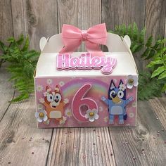 a pink box with an image of two cartoon characters and the number six on it