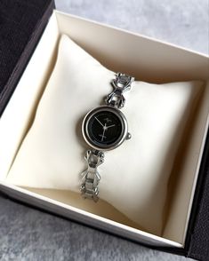 Vintage women's small watch with a beautiful bracelet. The watch looks very elegant on a woman's wrist and goes well with other accessories. This watch perfectly captures the vintage style! The watch will be a great gift for lovers of vintage accessories. The watch is delivered in a beautiful box, so it is perfect as a gift. Peculiarities The mechanism is quartz. The clock has a battery installed. Made in USSR. Case diameter - 21 mm (0.8 in) Bracelet length - 17,5 cm (7 inches) Year of issue - 1990s Case color - silver Dial color - black Condition - vintage, the watch is about 40 years old, but in very good condition. The clock works properly and shows the correct time. I will send the watch very quickly after purchase, as I am interested in you receiving your item as quickly as possible. Small Dial Watches Women, Women Vintage Watch, Retro Watches Vintage, Pretty Watches For Women, Small Watches Women Vintage, Black Watches Women, Vintage Women Watch, Watch Aesthetic Women, Black Watch Women's