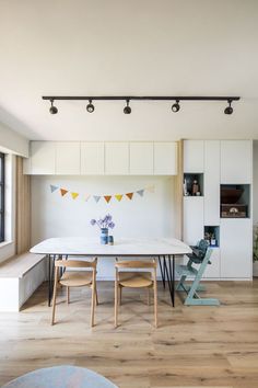 a dining table and chairs in a room