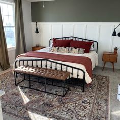 a bedroom with a bed, bench and rug