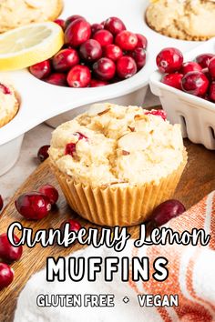 cranberry lemon muffins on a cutting board with fresh cranberries in the background