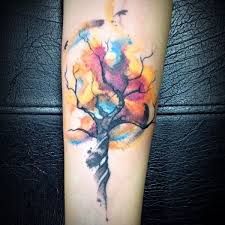 a colorful tree tattoo on the arm