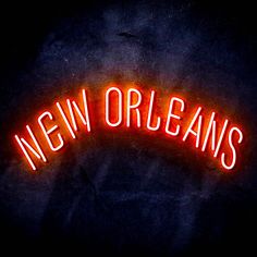 a neon sign that says new orleans in red on a black background with the word