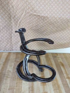 a metal sculpture sitting on top of a wooden table