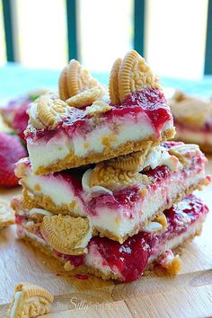 an image of some food that is on top of a wooden table with the caption golden oreo strawberry cheesecake bar