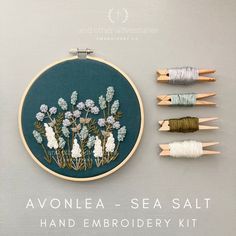 an embroidery kit with four different types of threads and flowers on the wall next to each other