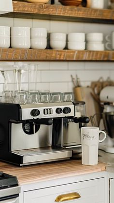 an espresso machine sitting on top of a counter next to a coffee maker