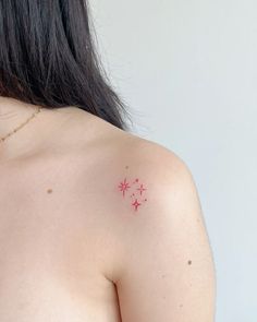 a woman's breast with small red stars on her left shoulder and the word love written in it