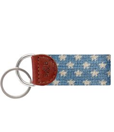 a blue and white keychain with a leather tag on it's side