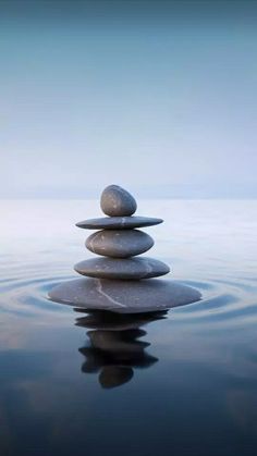 some rocks stacked on top of each other in the water