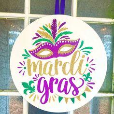 a mardi gras ornament hanging from a window