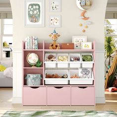 a child's room with pink shelves, toys and pictures on the wall above it