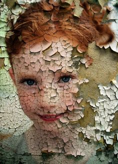 a child's face is shown through the cracked paint