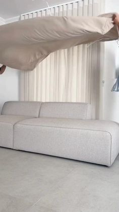 a person is hanging upside down on a couch