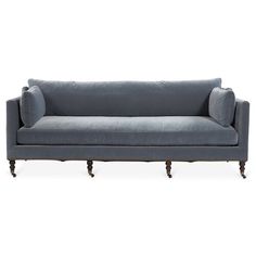 a gray couch sitting on top of a white floor