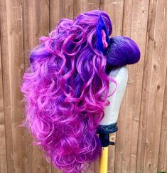 a wig with purple hair on top of a mannequin