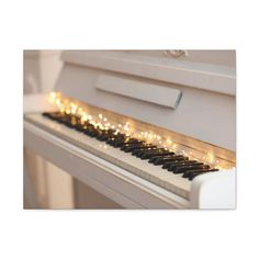 a white piano with some lights on it