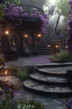 a set of stone steps leading up to a house with purple flowers growing on it