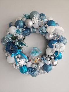 a blue and white christmas wreath hanging on the wall