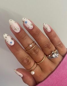 Evil eye nails are an excellent way to keep bad karma away – here are 25 simple designs that we love for spring and summer! This milky white manicure is just one idea that we love. Milky White Nails With Pink Design, Milky Summer Nails, Summer White Nails With Designs, Simple Summer Nails White, White Nails With Evil Eye, Summer Nails White Design, Evil Eye Gel Nails, Summer 2024 Nails Design, Simple Evil Eye Nails