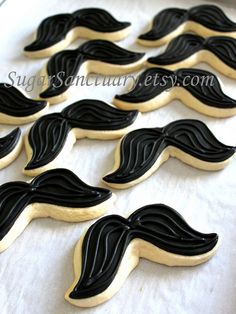 cookies decorated with black icing and mustaches