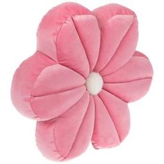 a pink flower shaped pillow sitting on top of a white surface