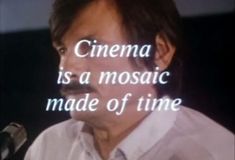 a man is speaking into a microphone with the words cinema is a mosaic made of time