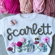 three balls of yarn with the word scarft written on them in different colors and sizes