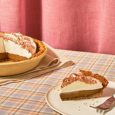 a pie sitting on top of a table next to a plate with a slice missing