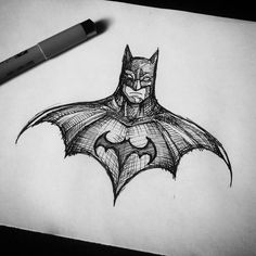 a drawing of the batman symbol on paper